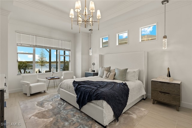 bedroom featuring a water view, ornamental molding, and an inviting chandelier