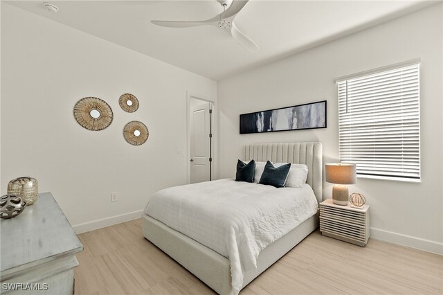 bedroom with ceiling fan and light wood-type flooring