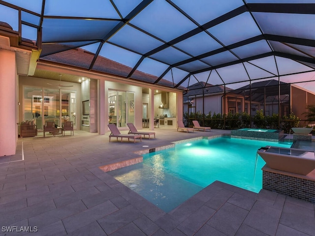 view of swimming pool featuring an in ground hot tub, a patio, ceiling fan, and a lanai