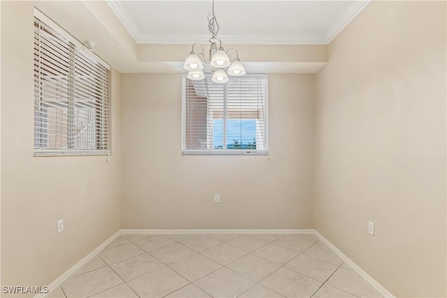 empty room featuring a notable chandelier, ornamental molding, and light tile patterned floors