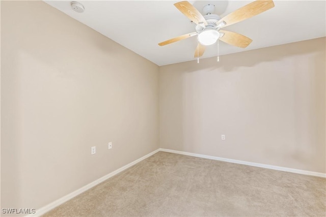 carpeted spare room featuring ceiling fan