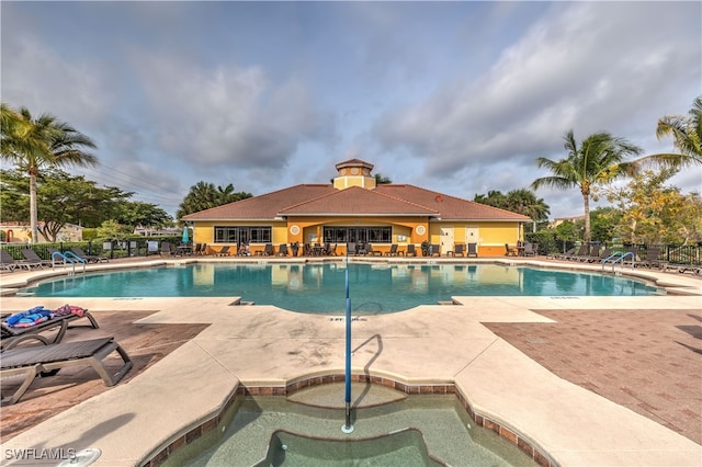 view of swimming pool featuring a patio area and a community hot tub