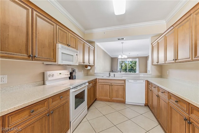 kitchen with sink, white appliances, ornamental molding, and decorative light fixtures