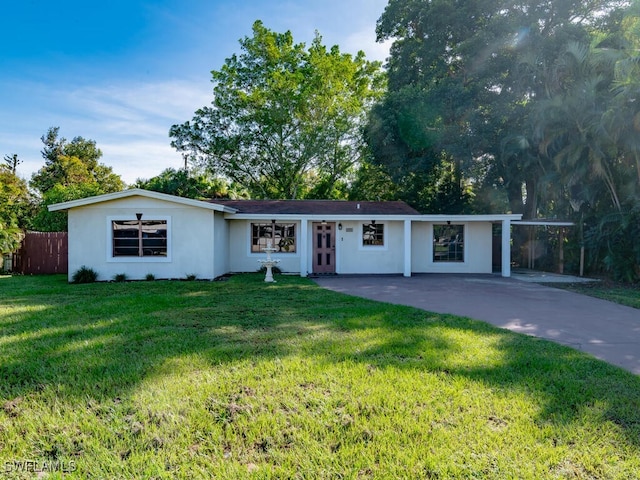 ranch-style home featuring a front yard and a carport