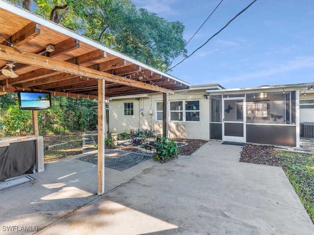 view of patio featuring a sunroom