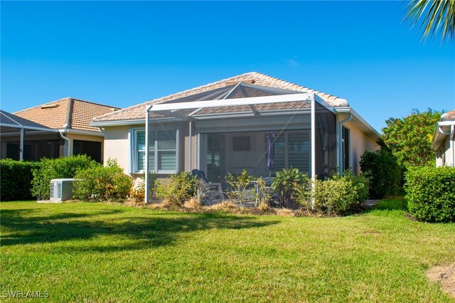 view of front of house featuring glass enclosure and a front lawn