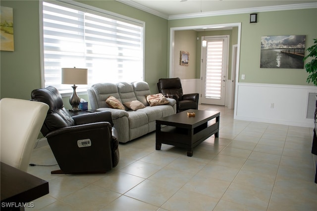 tiled living room with ceiling fan and ornamental molding