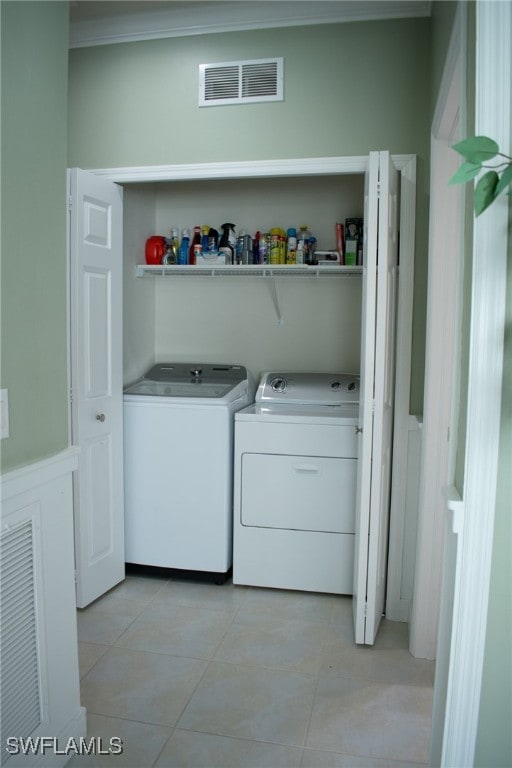 washroom with light tile patterned flooring and separate washer and dryer