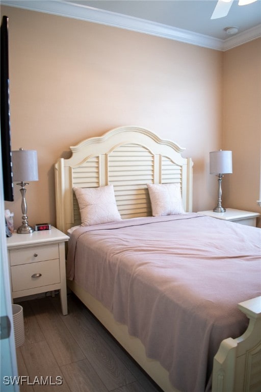 bedroom with ceiling fan, crown molding, and dark hardwood / wood-style floors