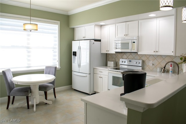 kitchen with pendant lighting, white cabinets, kitchen peninsula, crown molding, and white appliances