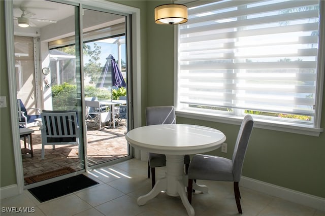 tiled dining space featuring ceiling fan