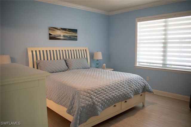 bedroom featuring hardwood / wood-style flooring and ornamental molding