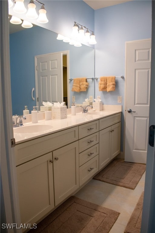 bathroom with tile patterned floors and vanity