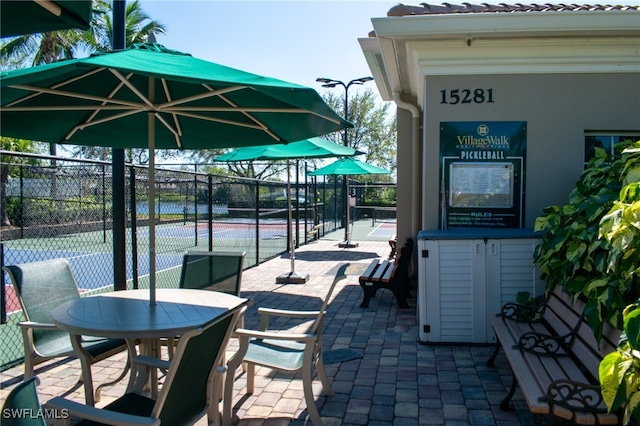 view of patio / terrace featuring tennis court