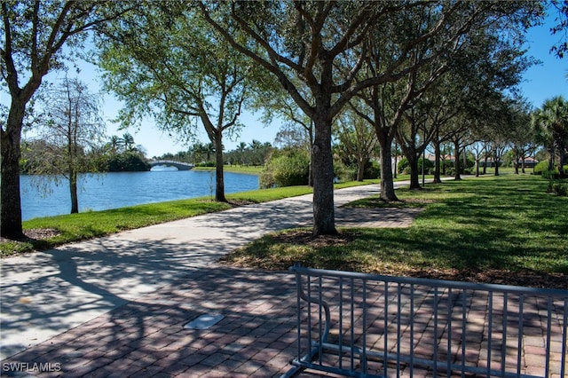 view of community with a water view and a lawn