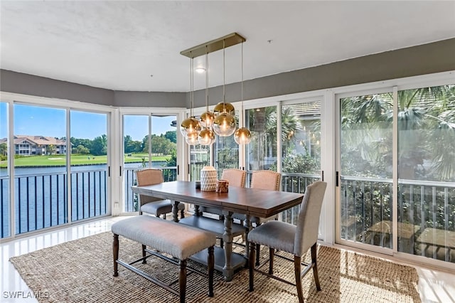 sunroom featuring plenty of natural light and a chandelier