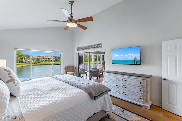 bedroom featuring ceiling fan, hardwood / wood-style floors, high vaulted ceiling, and access to outside