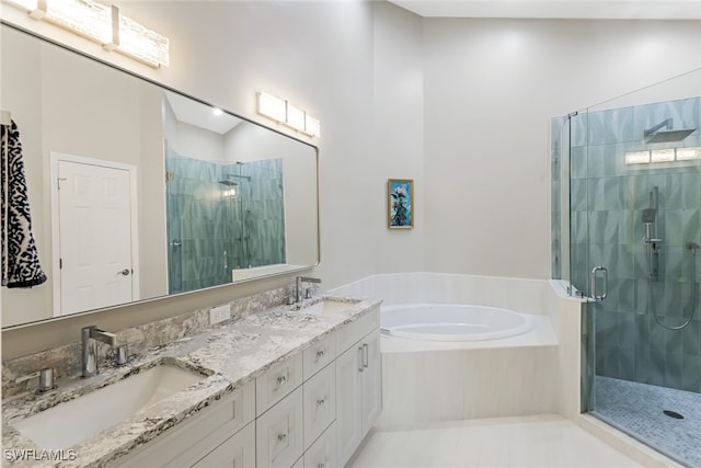 bathroom featuring vanity and shower with separate bathtub