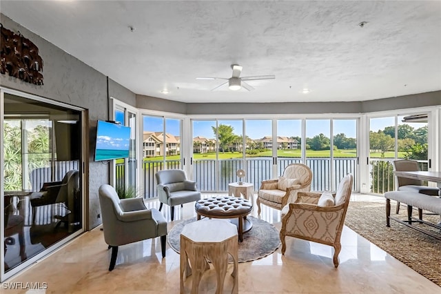 sunroom featuring plenty of natural light and ceiling fan