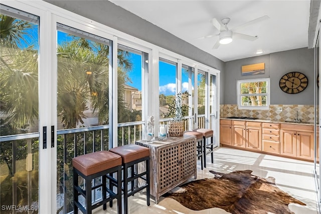 sunroom / solarium with sink and ceiling fan