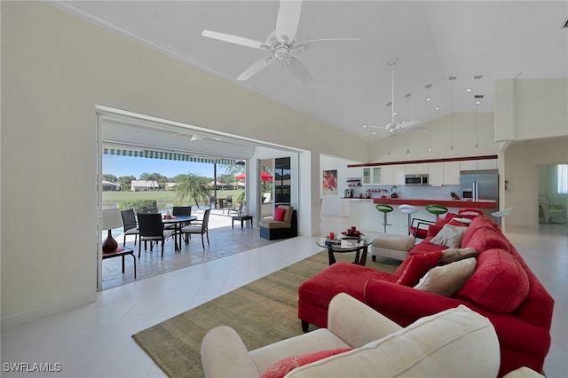 living room with light tile patterned floors, high vaulted ceiling, ceiling fan, and ornamental molding