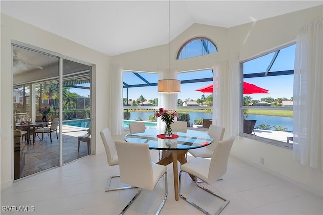 sunroom / solarium with plenty of natural light, a water view, and lofted ceiling