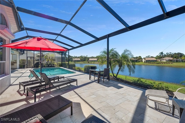 view of patio / terrace with a lanai and a water view