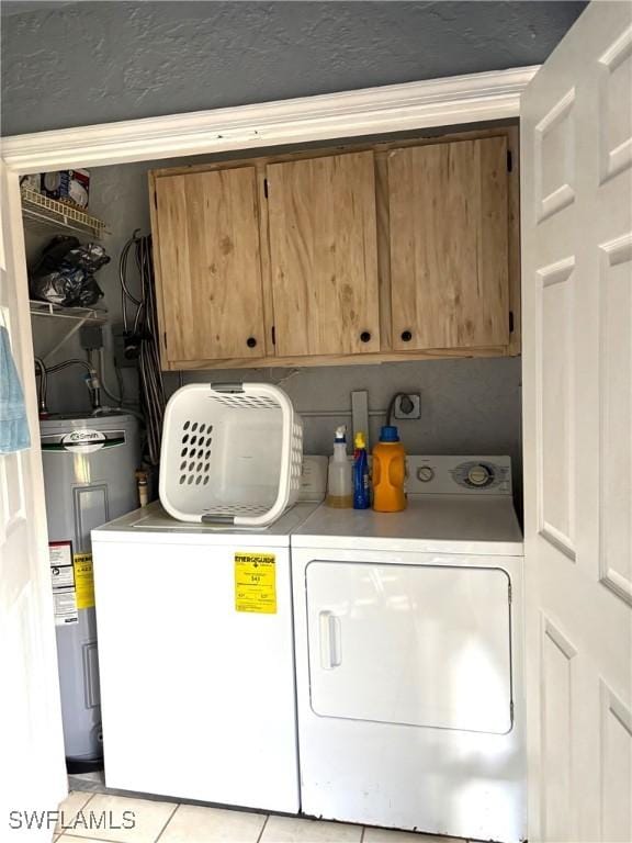 laundry room featuring cabinets, light tile patterned flooring, separate washer and dryer, and water heater