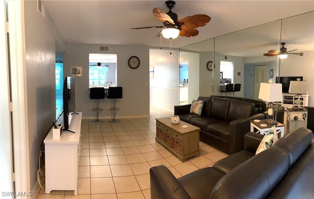 tiled living room featuring ceiling fan