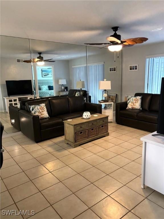 tiled living room featuring ceiling fan