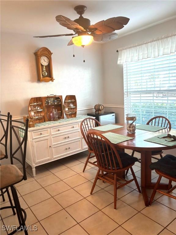 dining space with light tile patterned floors and ceiling fan