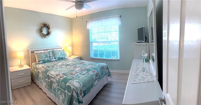 bedroom with wood-type flooring and ceiling fan