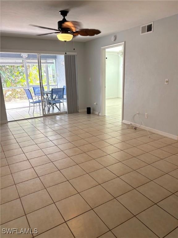 spare room featuring ceiling fan and light tile patterned floors