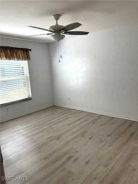 unfurnished room featuring ceiling fan and light wood-type flooring