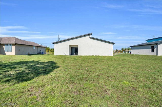 back of property featuring a lawn