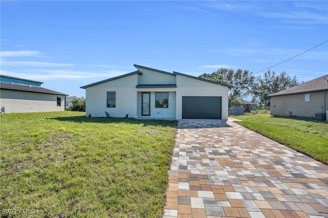 view of front of property with a garage and a front lawn