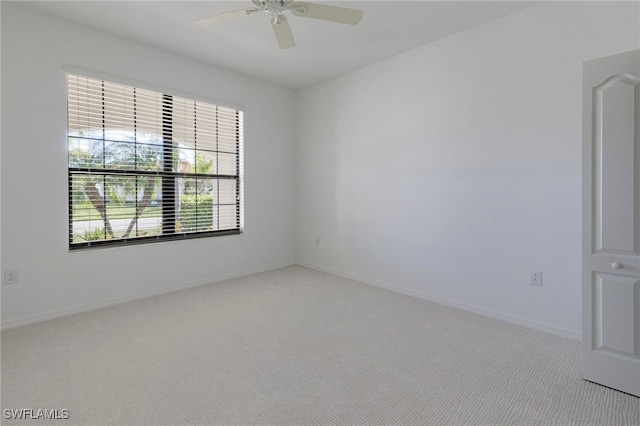 spare room with light carpet and ceiling fan