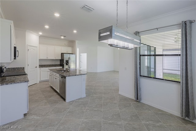 kitchen with a center island with sink, white cabinetry, sink, and appliances with stainless steel finishes