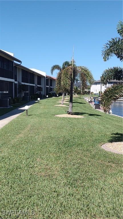 view of community featuring a water view and a yard