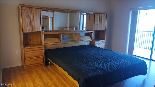 bedroom with access to exterior and light hardwood / wood-style flooring