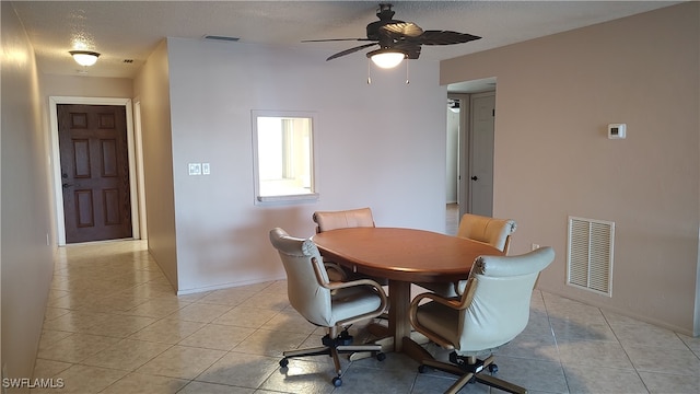 dining area with light tile patterned floors, a textured ceiling, and ceiling fan