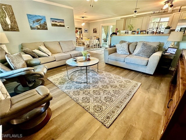 living room with hardwood / wood-style flooring and ornamental molding