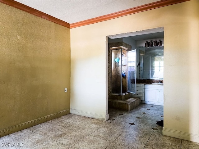 hall featuring a textured ceiling, crown molding, and light tile patterned flooring