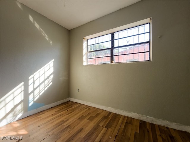 unfurnished room with wood-type flooring