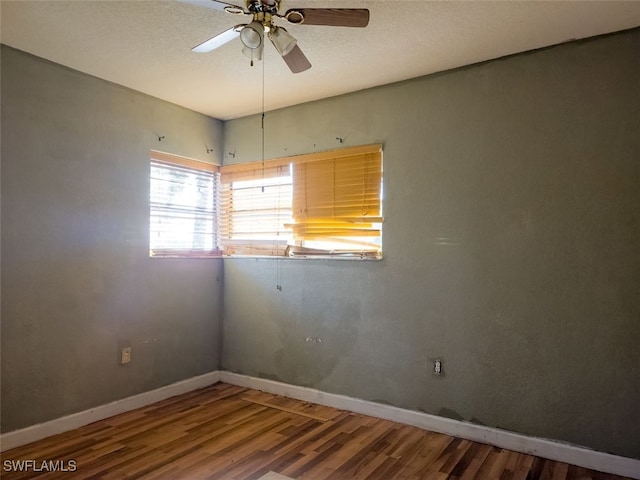 unfurnished room featuring wood-type flooring, a textured ceiling, and ceiling fan