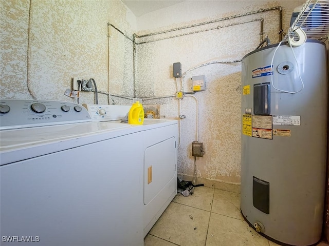 washroom with washer and clothes dryer, light tile patterned flooring, and water heater