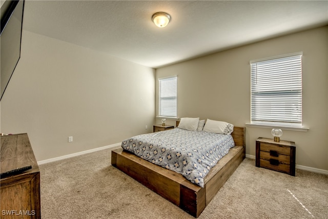 bedroom with light colored carpet