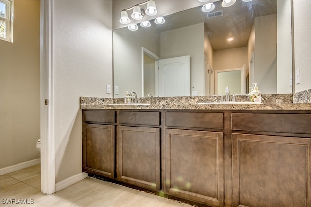 bathroom featuring tile patterned flooring, vanity, and toilet