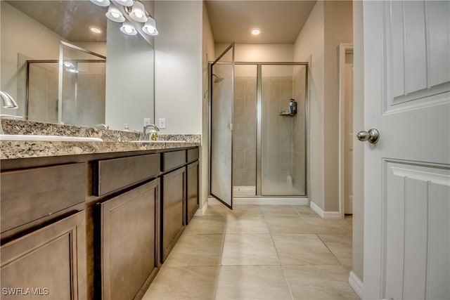 bathroom featuring vanity, tile patterned floors, and an enclosed shower