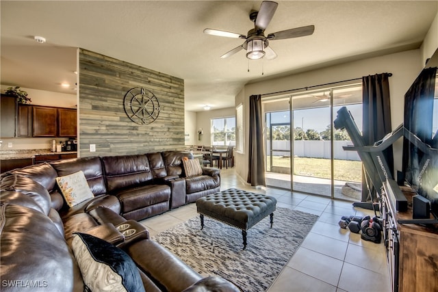 tiled living room featuring ceiling fan